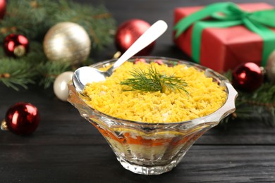 Traditional russian salad Mimosa and festive decor on dark wooden table