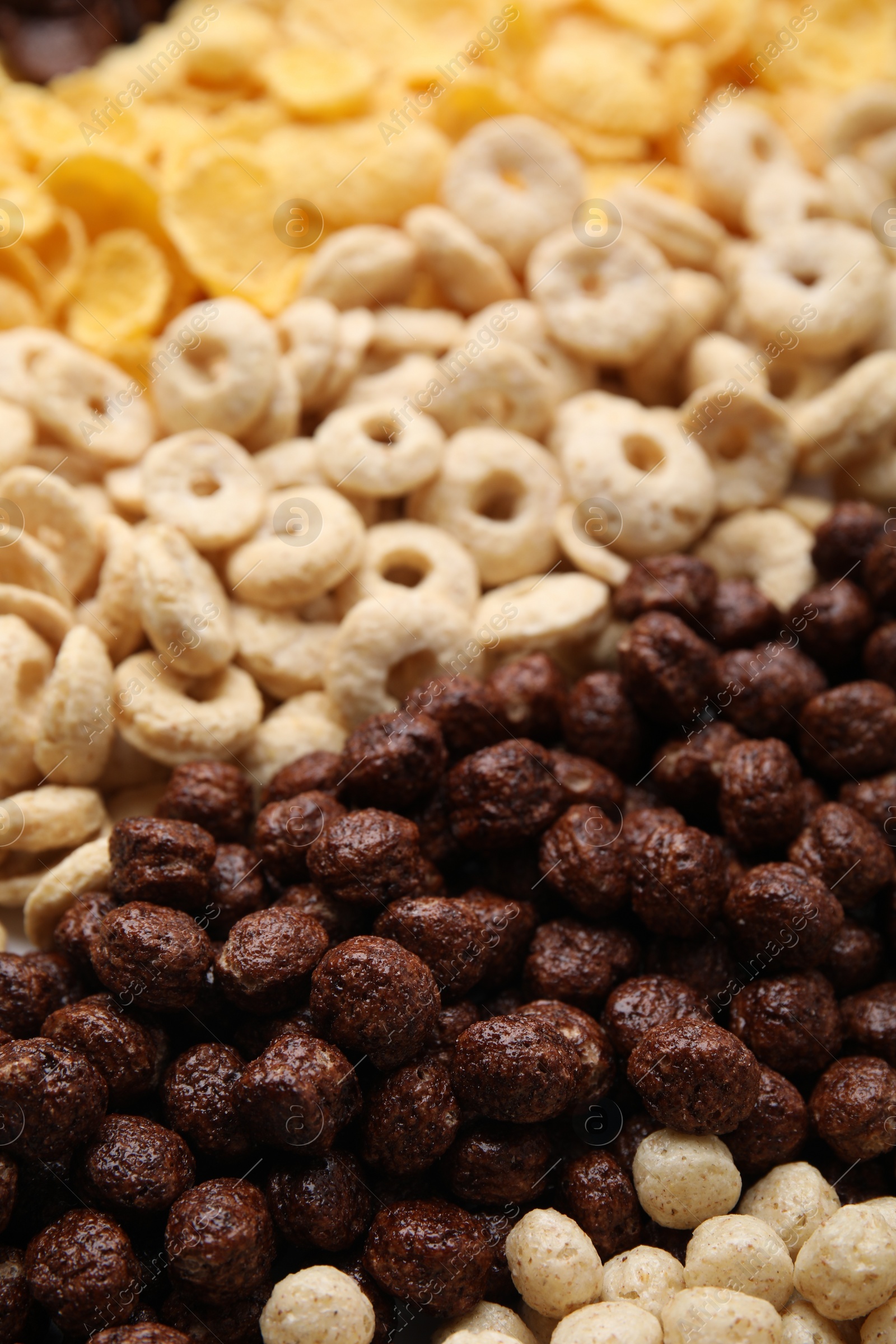 Photo of Different types of breakfast cereals as background, closeup