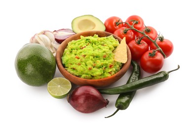 Photo of Delicious guacamole with nachos chips and ingredients isolated on white