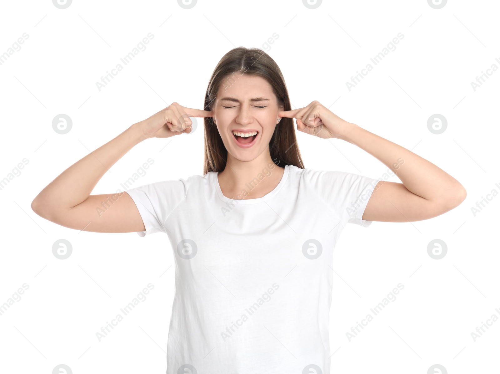 Photo of Emotional young woman covering her ears with fingers on white background