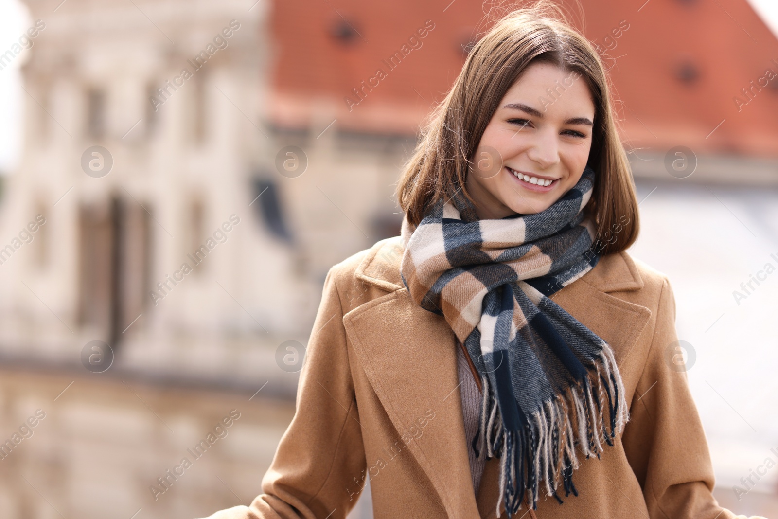 Photo of Beautiful woman in warm scarf outdoors, space for text