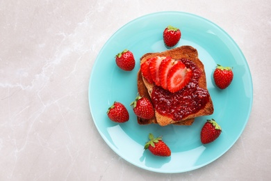 Photo of Toasts with jam and strawberries on light grey marble table, top view. Healthy breakfast