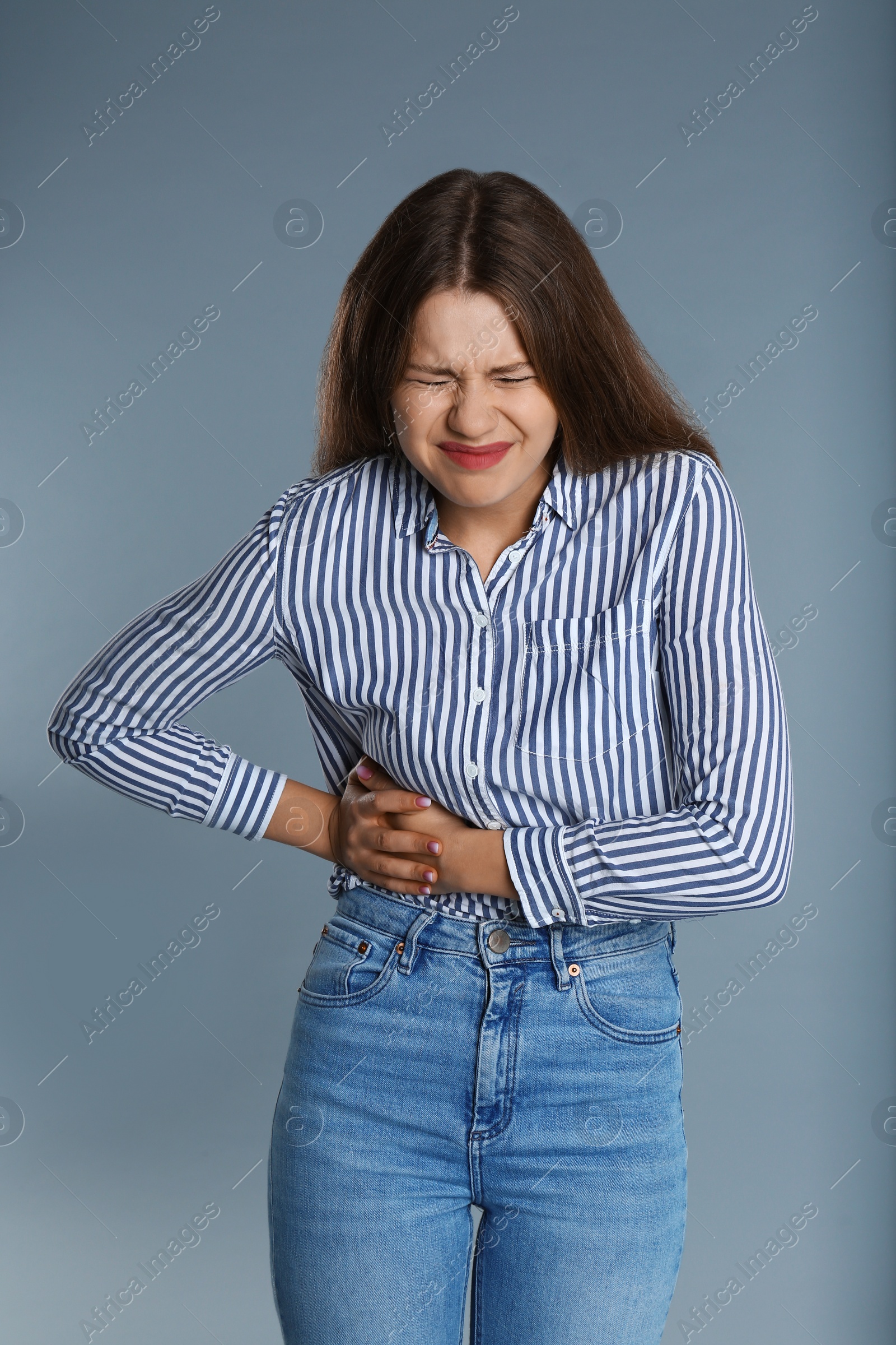 Photo of Woman suffering from pain in right side on grey background