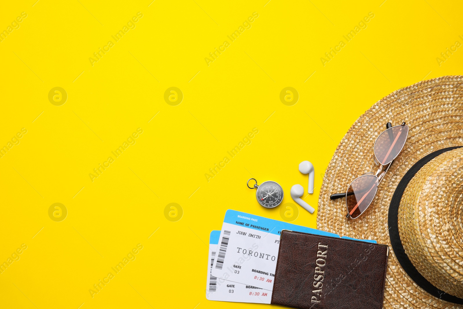 Photo of Flat lay composition with passport, tickets and travel items on yellow background. Space for text