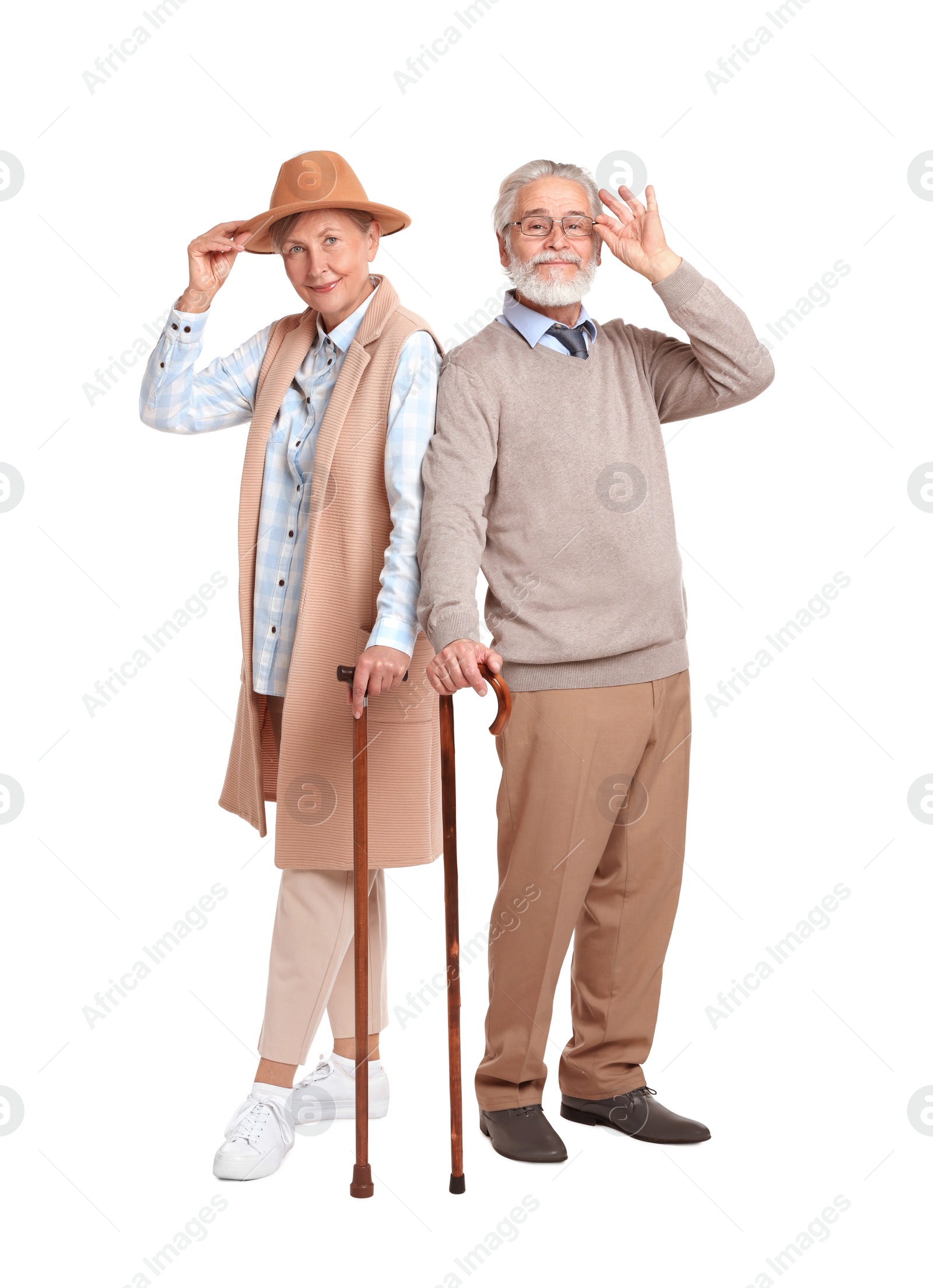 Photo of Senior man and woman with walking canes on white background