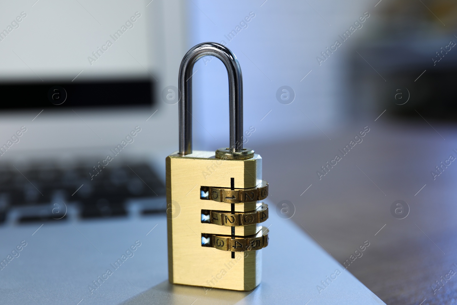 Photo of Cyber security. Laptop with padlock on table, closeup