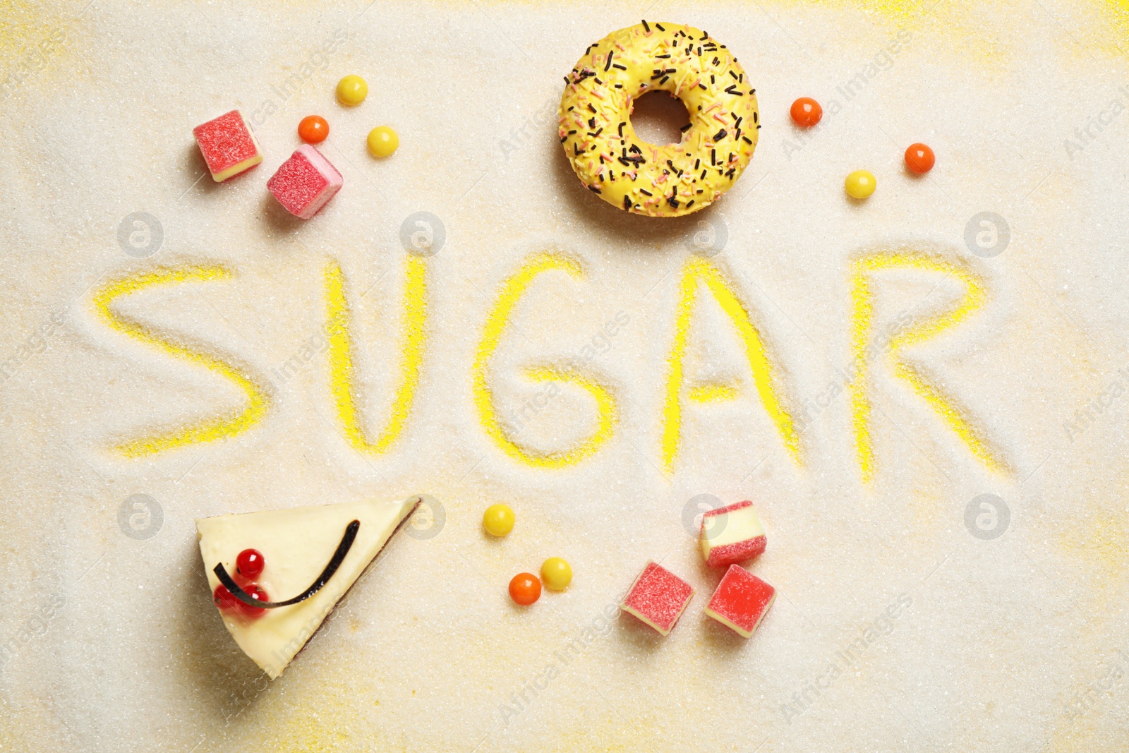 Photo of Flat lay composition with sweets and word SUGAR on yellow background