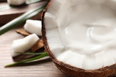 Photo of Ripe coconut with cream on table, closeup