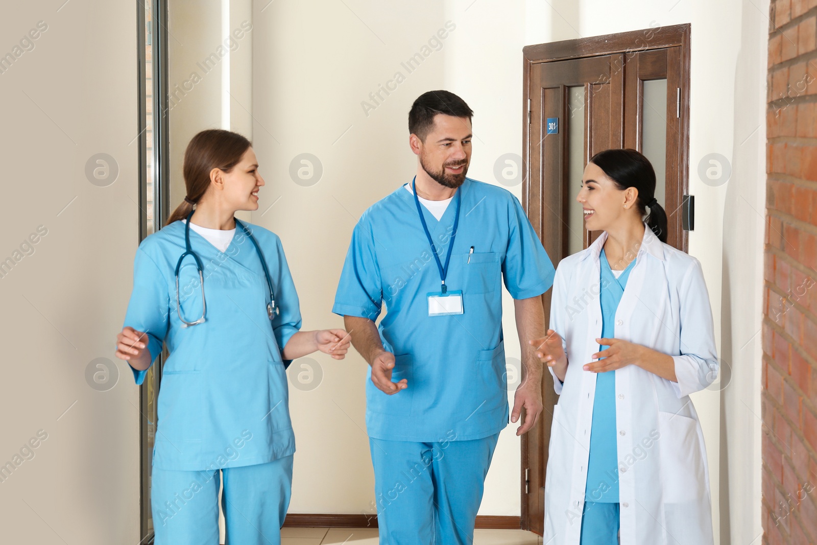 Photo of Group of doctors walking in clinic. Medical service