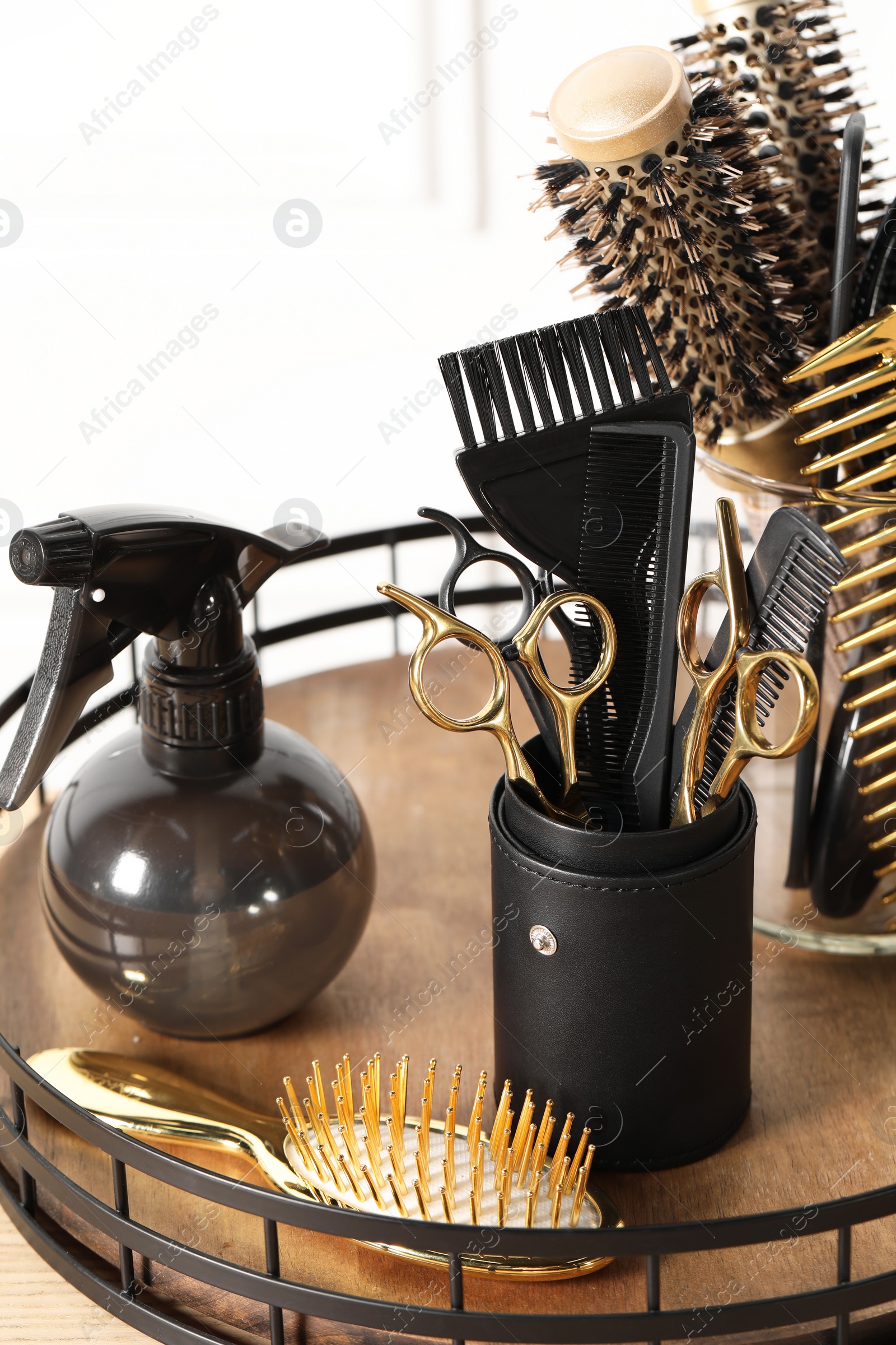 Photo of Set of hairdresser tools on table in salon