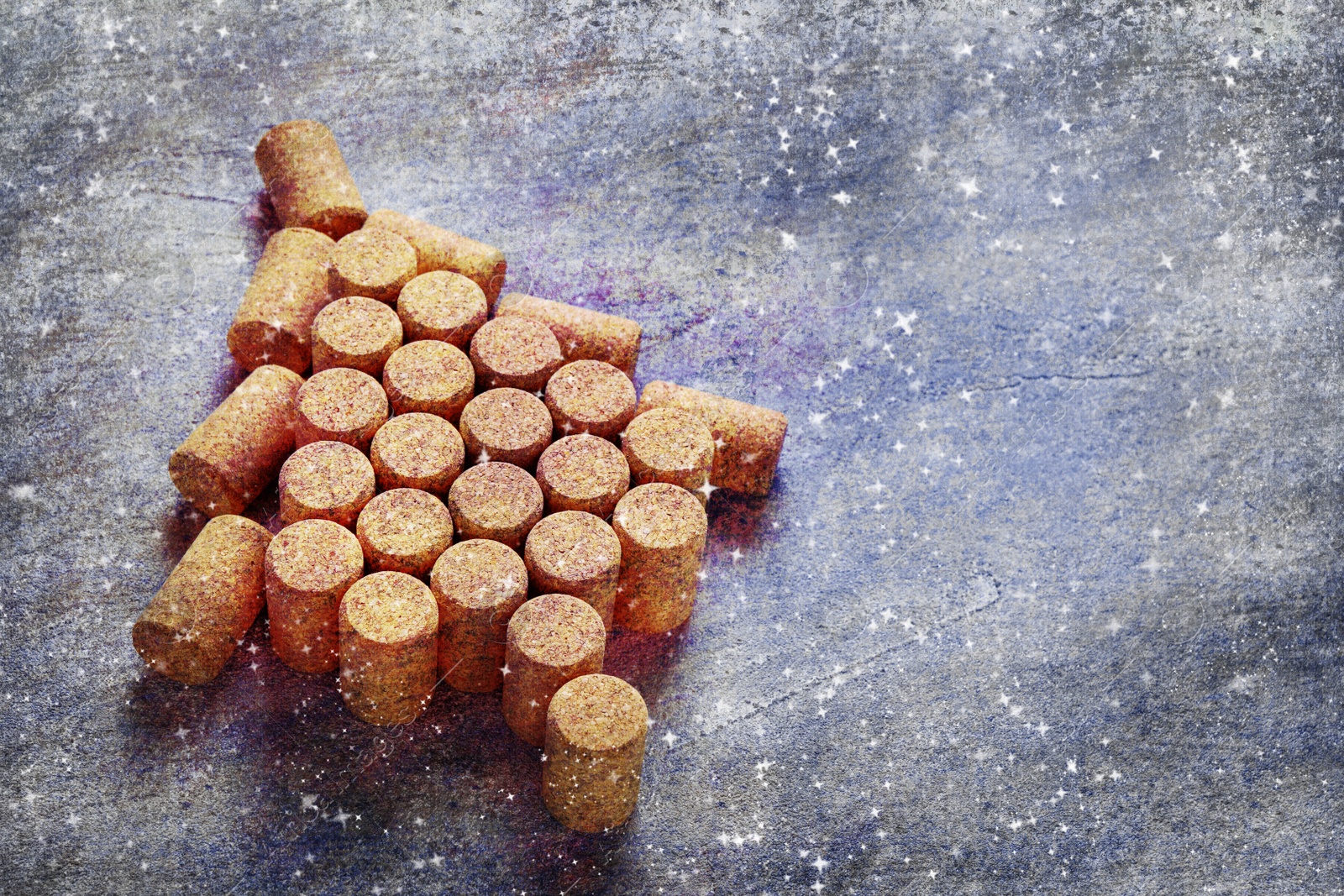 Image of Christmas tree made of wine corks on grey table. Space for text