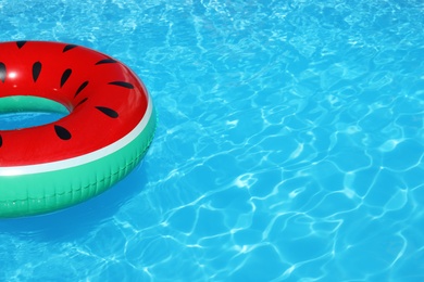 Photo of Inflatable ring floating in swimming pool on sunny day. Space for text