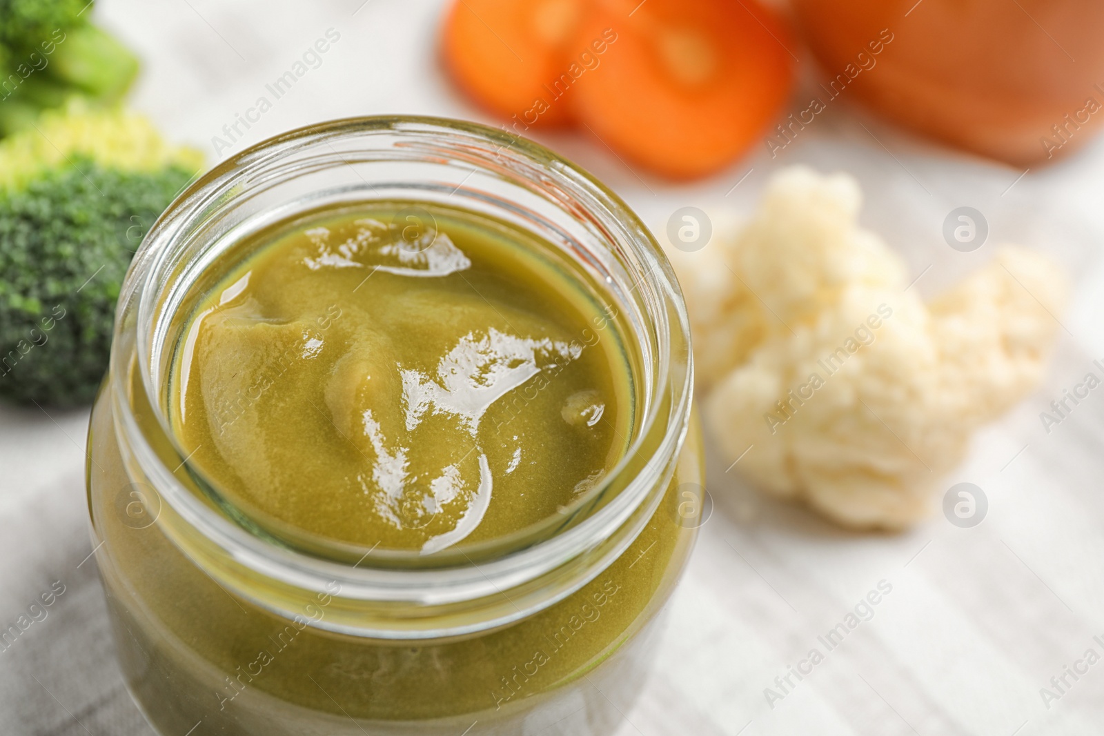 Photo of Healthy baby food and fresh ingredients on table, closeup