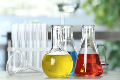 Image of Laboratory glassware with different liquid samples on table