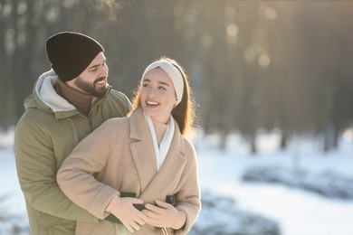 Beautiful young couple enjoying winter day outdoors