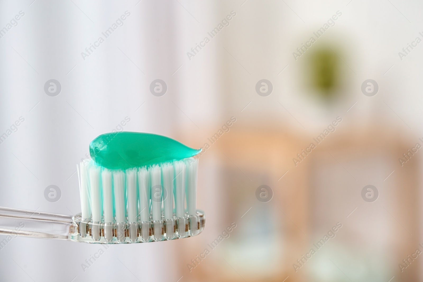 Photo of Toothbrush with paste on blurred background, closeup