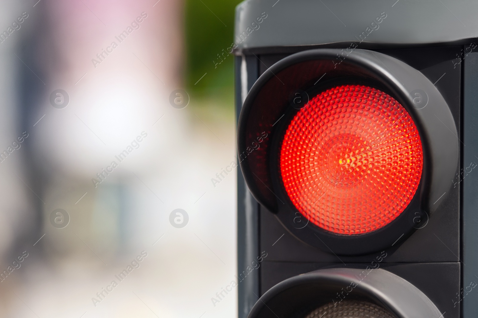 Photo of Traffic light on blurred background, closeup. Space for text