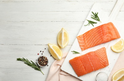 Photo of Flat lay composition with salmon fillet on white wooden table. Space for text