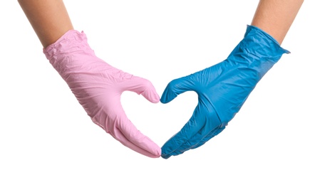 Photo of Doctor making heart with hands in different medical gloves on white background