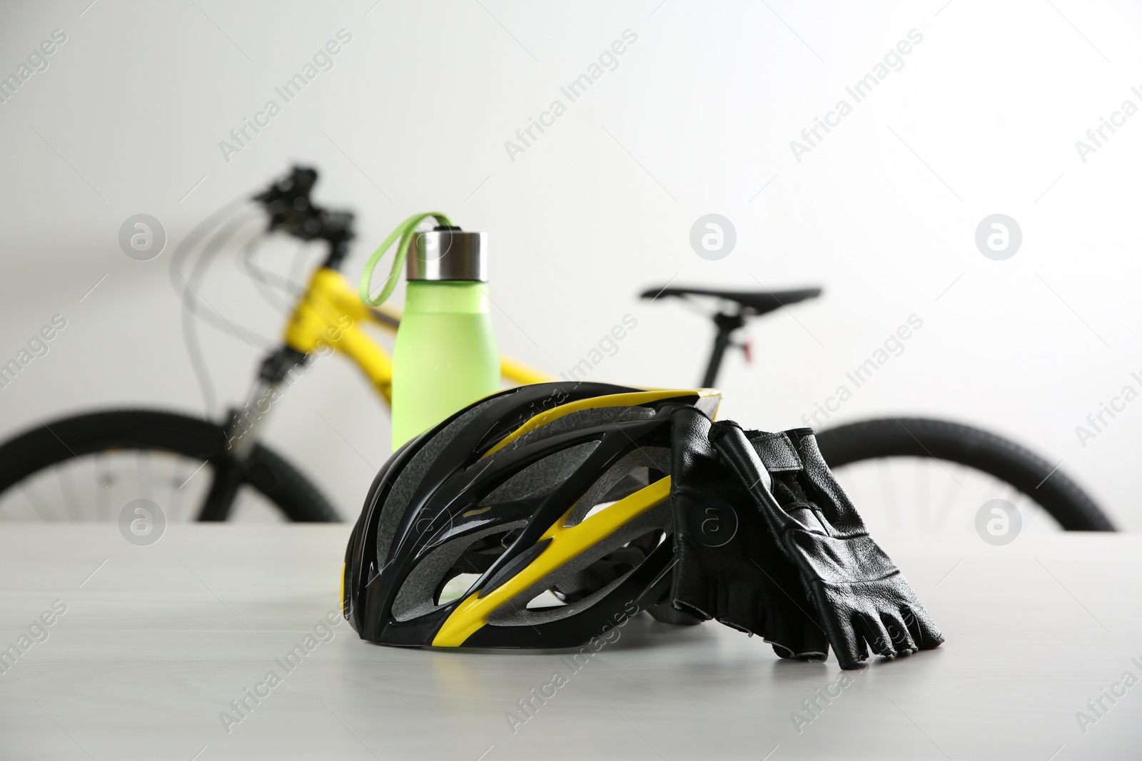 Photo of Bicycle helmet and gloves on white table