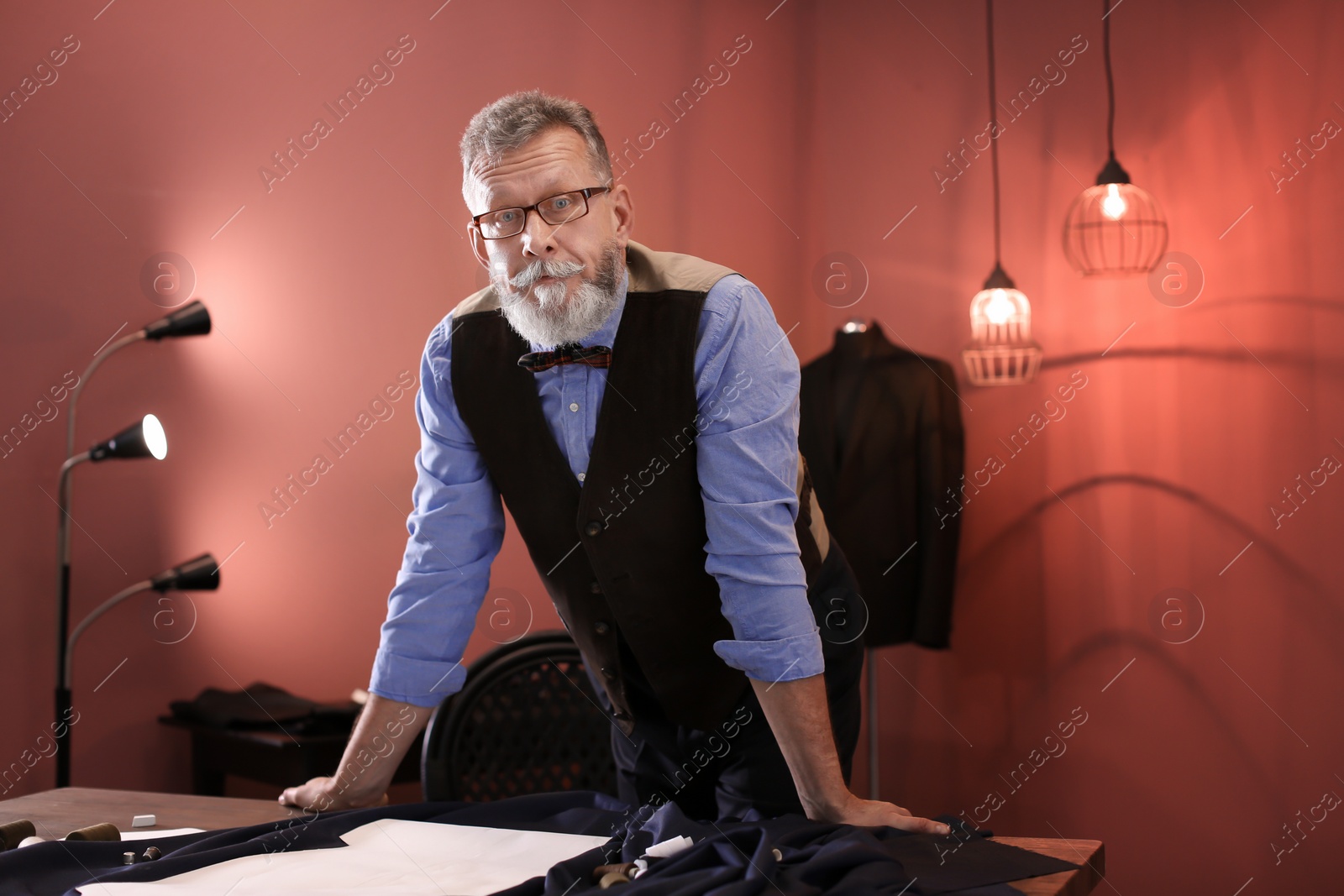 Photo of Portrait of mature tailor in atelier