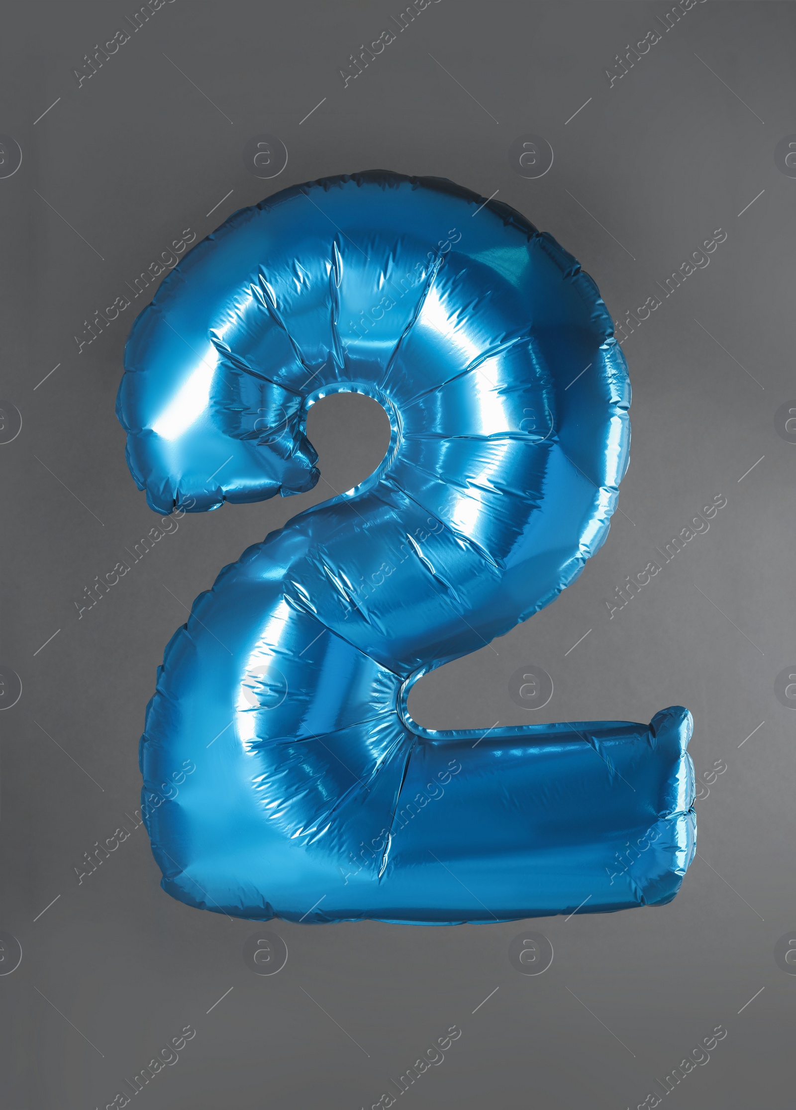 Photo of Blue number two balloon on grey background