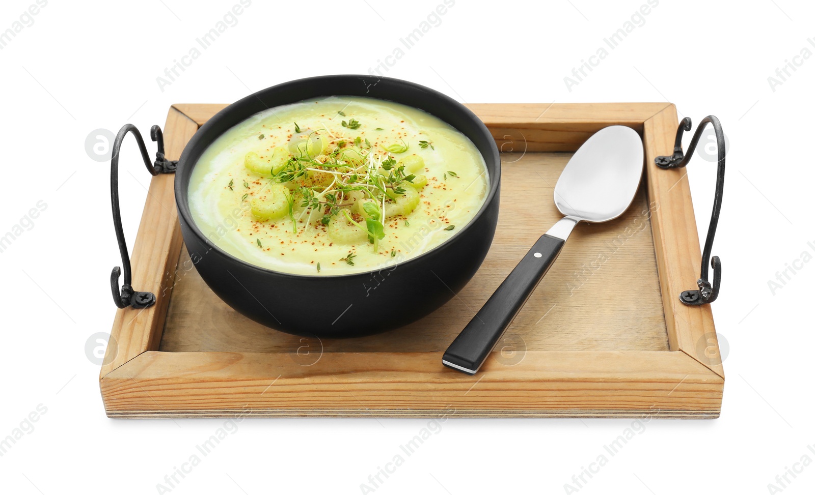 Photo of Wooden tray with bowl of delicious celery soup and spoon isolated on white