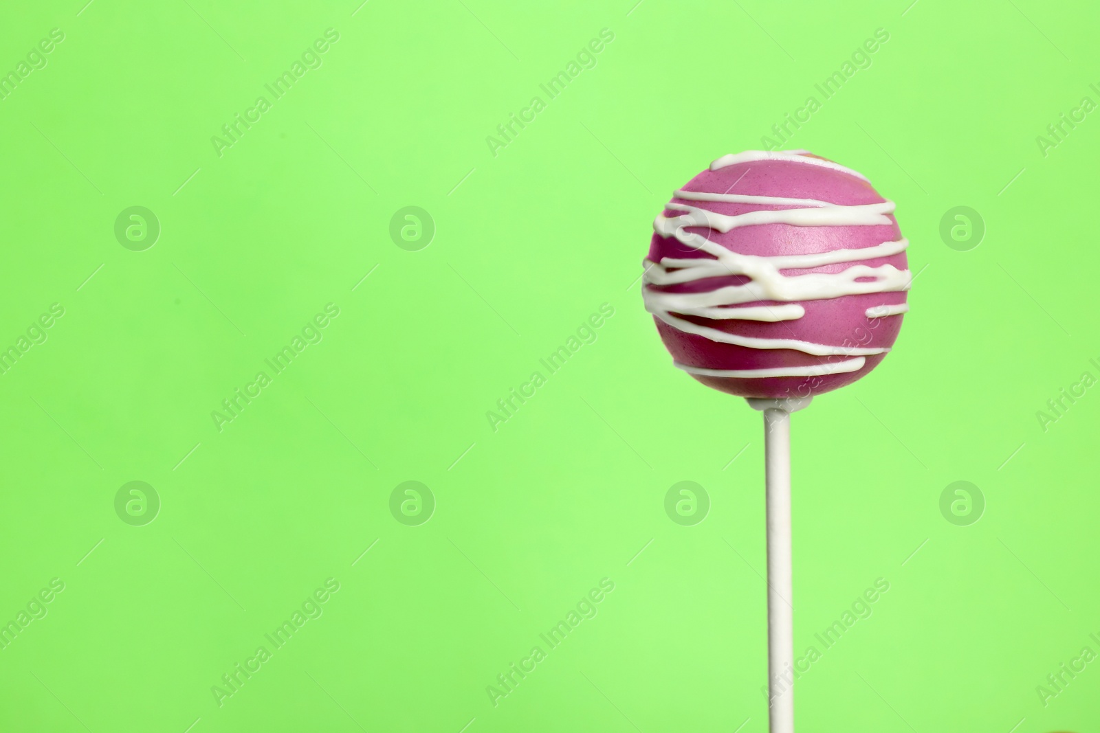 Photo of Bright delicious cake pop on color background. Space for text