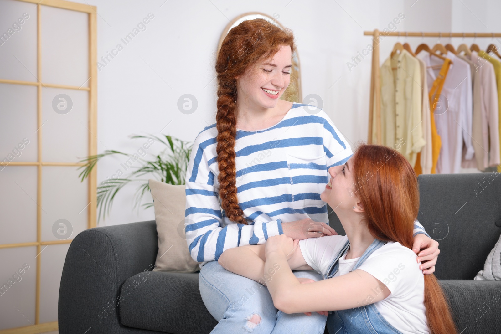 Photo of Portrait of beautiful young redhead sisters at home