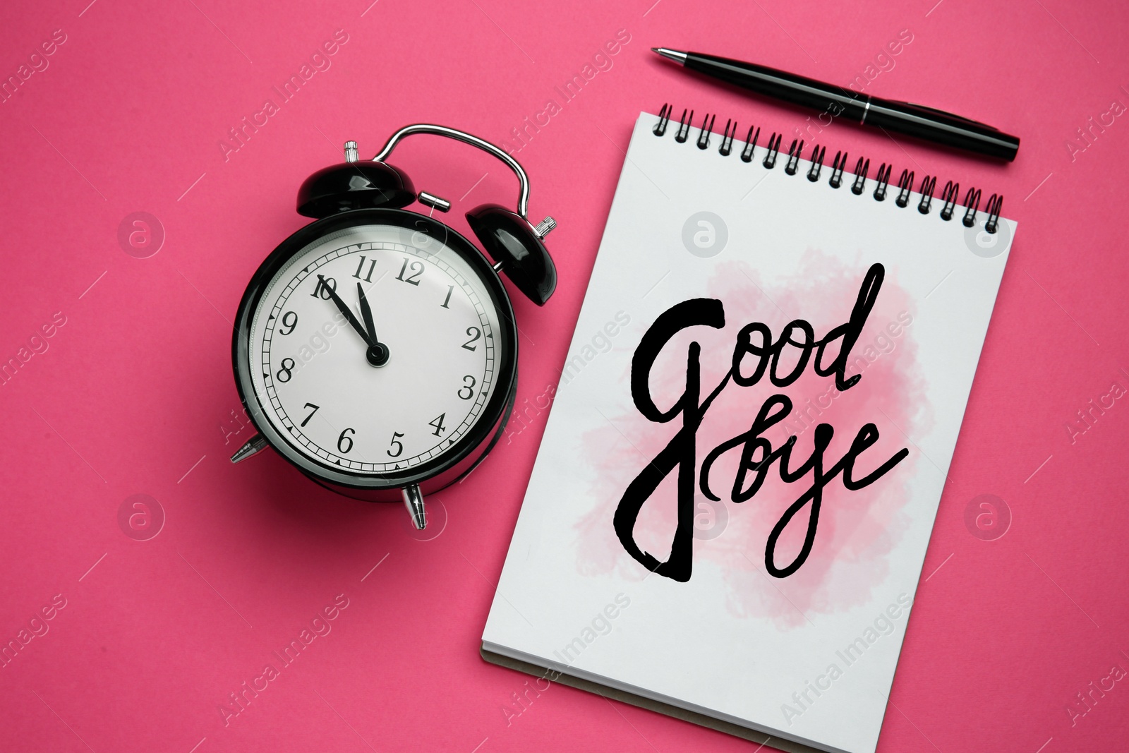 Image of Notebook with word Goodbye, alarm clock and pen on pink background, flat lay