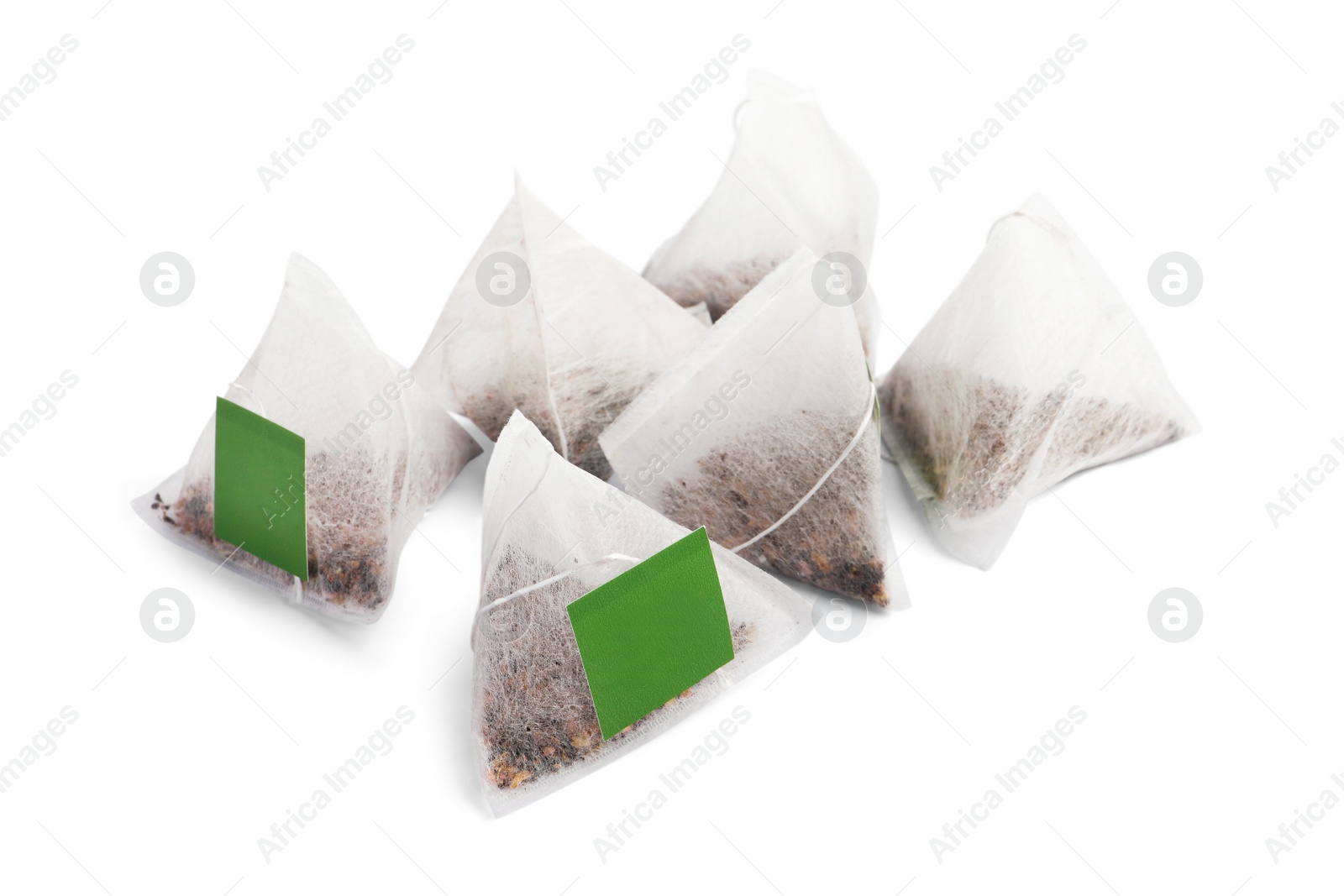 Photo of Many new pyramid tea bags on white background