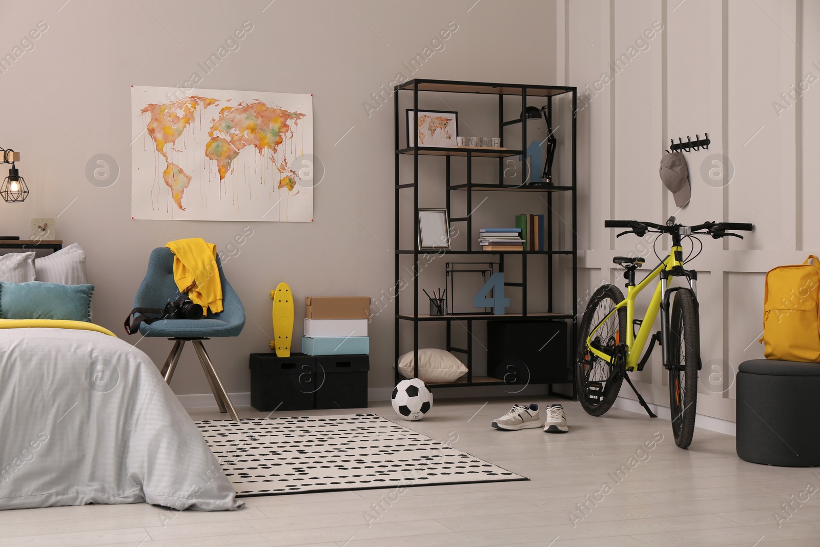 Photo of Stylish teenager's room interior with comfortable bed and sports equipment