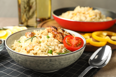 Photo of Delicious chicken risotto with tomato on table, closeup