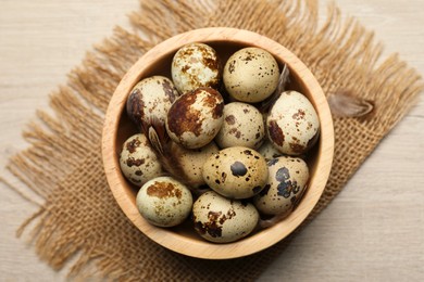 Photo of Speckled quail eggs on white table, top view