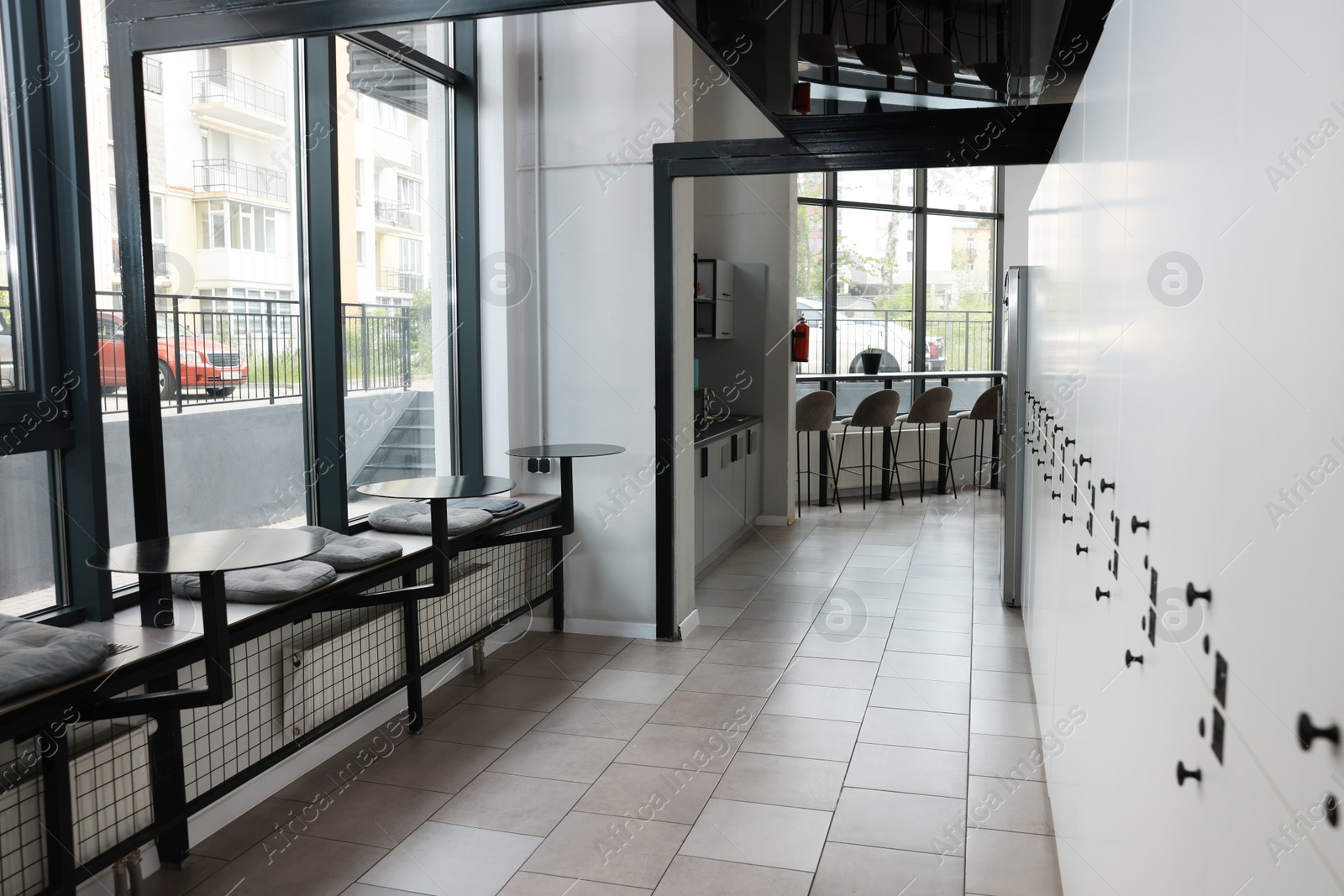 Photo of Hostel dining room interior with modern furniture and white lockers