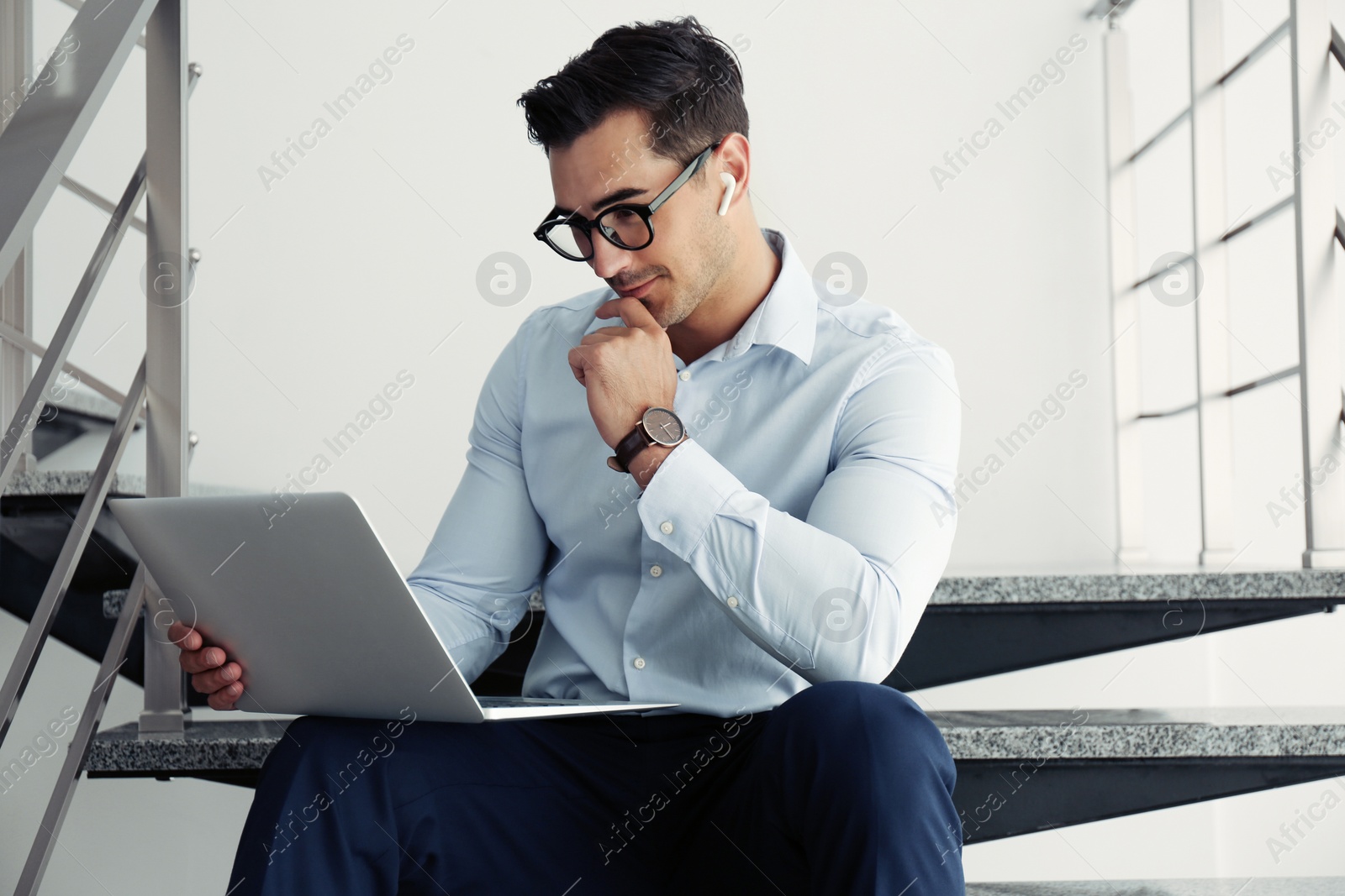 Photo of Portrait of young man with laptop indoors