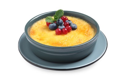 Photo of Delicious creme brulee with fresh berries isolated on white