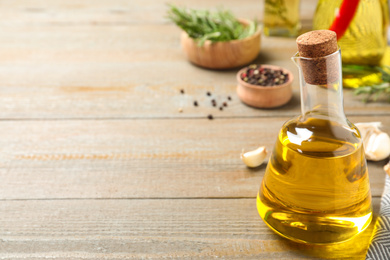 Cooking oil on wooden table. Space for text