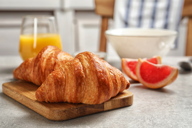 Tasty fresh croissants on light grey table. Healthy breakfast