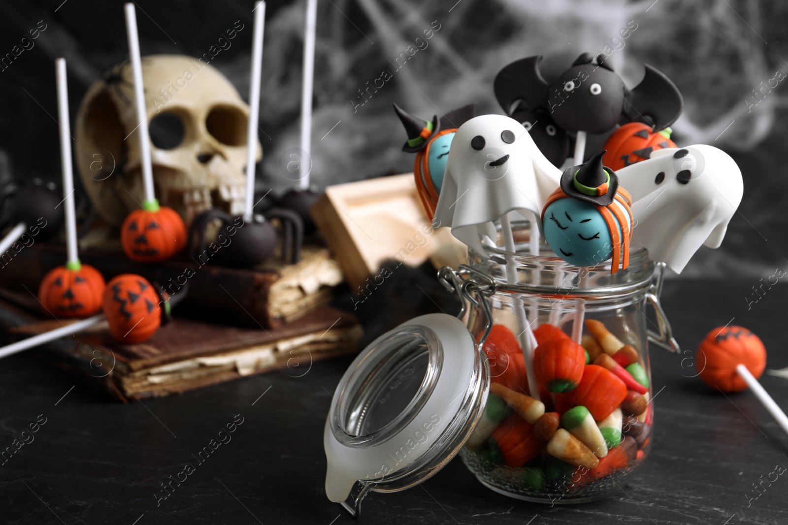 Photo of Different Halloween themed cake pops on black table