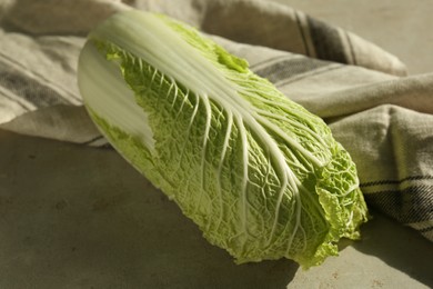 Photo of Fresh ripe Chinese cabbage on gray textured table, closeup