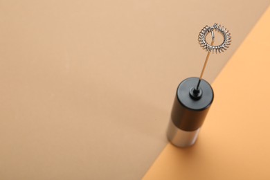 Photo of Milk frother wand on color background, above view. Space for text