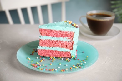 Slice of fresh delicious birthday cake on table indoors