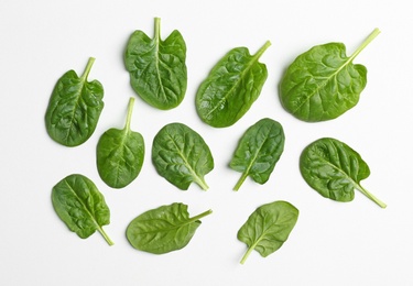 Photo of Fresh leaves of spinach isolated on white, top view