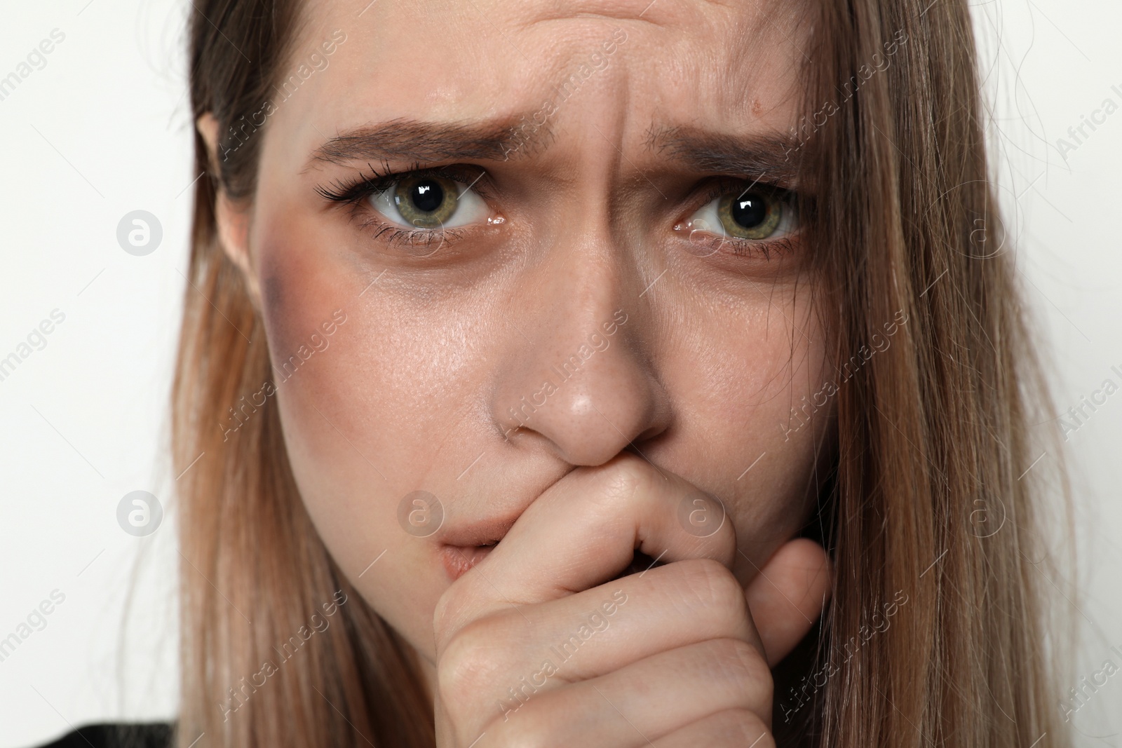 Photo of Abused young woman on light background, closeup. Stop violence