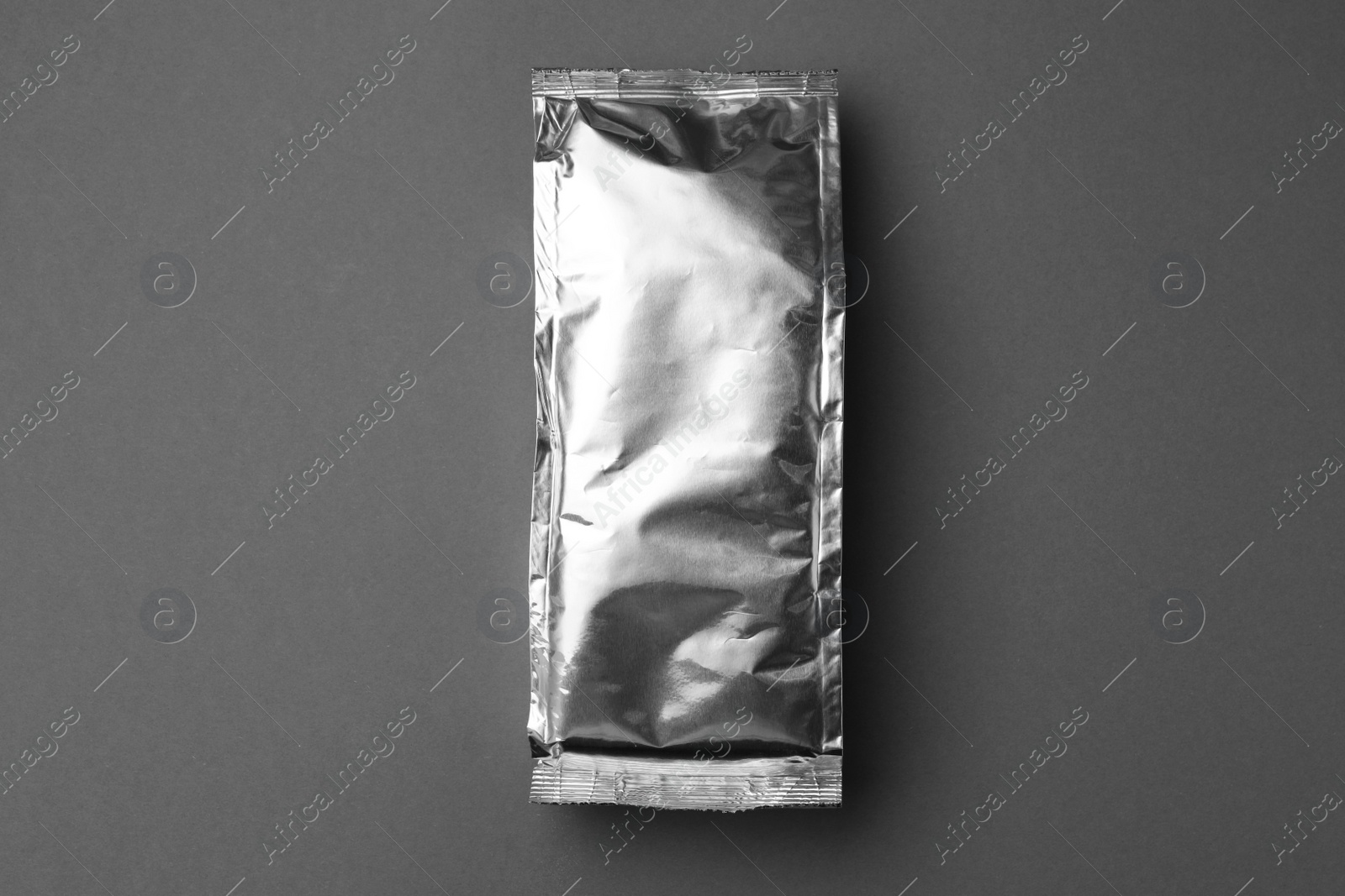 Photo of Blank foil package on grey background, top view