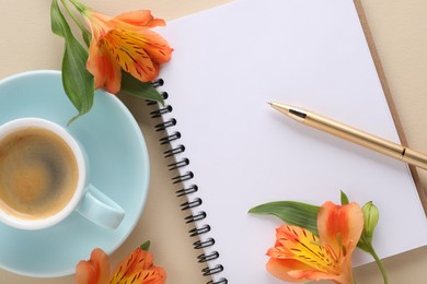 Guest list. Notebook, pen, coffee and beautiful flowers on beige table, flat lay. Space for text