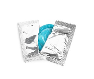 Torn condom package isolated on white, top view. Safe sex