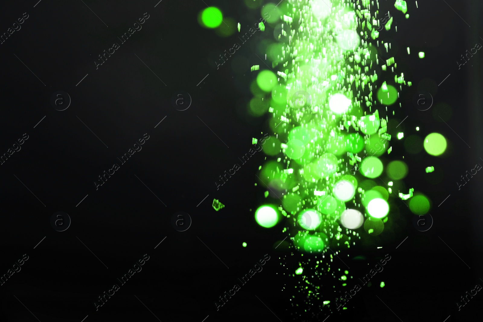 Image of St. Patrick day. Shiny green glitter on black background, bokeh effect