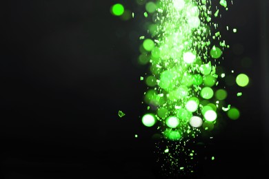 Image of St. Patrick day. Shiny green glitter on black background, bokeh effect